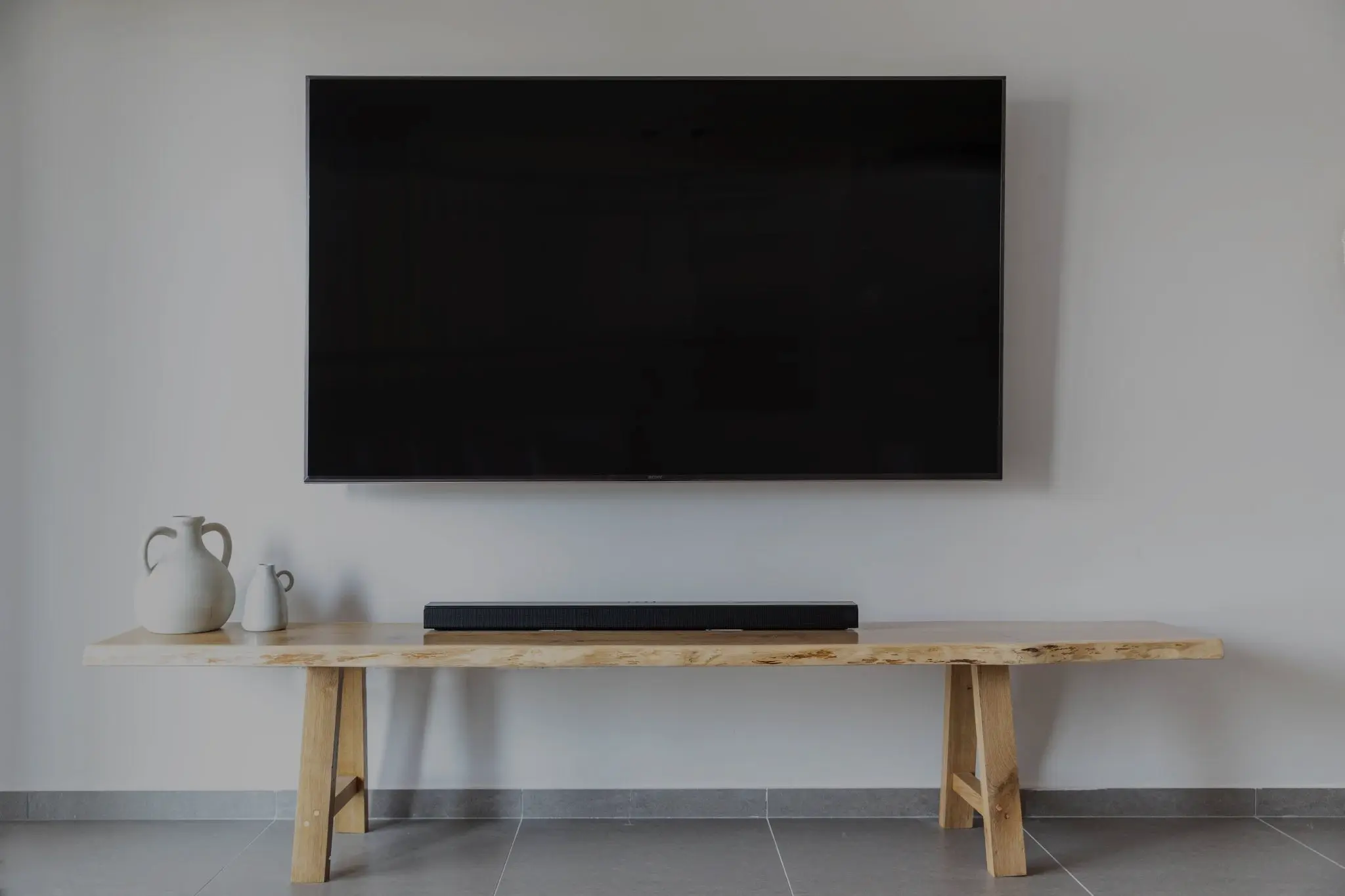 Illustrative wall-mounted television above a console